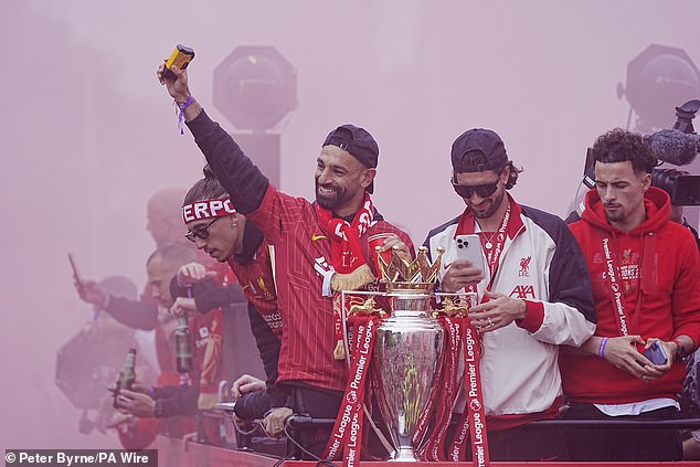 The midfielder was front and centre as he waved to supporters who cheered him and his team-mates on the bus