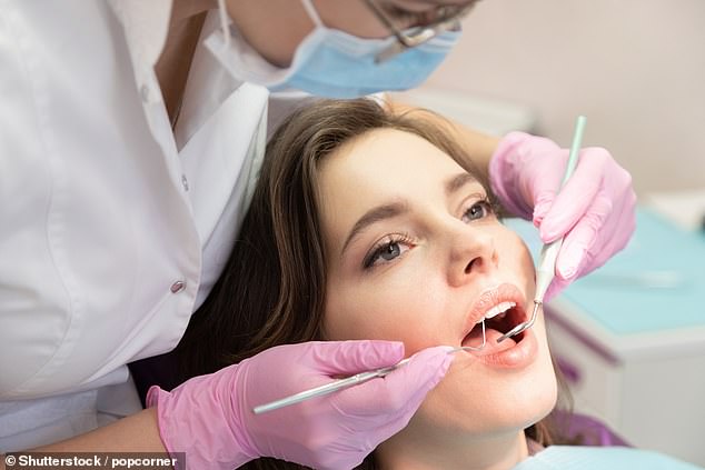 Dentists have weighed in on how best to keep your teeth healthy - with some common 'healthy' habits actually wrecking havoc on your pearly whites (stock image)
