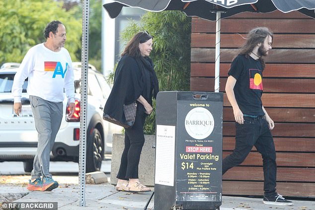 She dressed casually in black pants, a matching coloured top and wrapped a shawl around her neck