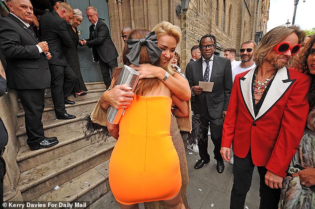 Davina gave Claire a warm hug as they greeted each other outside the venue