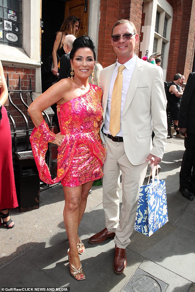 Jessie Wallace turned heads in a pink off the shoulder mini dress as she attended the wedding with her boyfriend Justin Gallwey