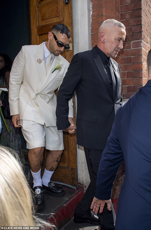 Tony and Stavros held hands outside the venue on their special day