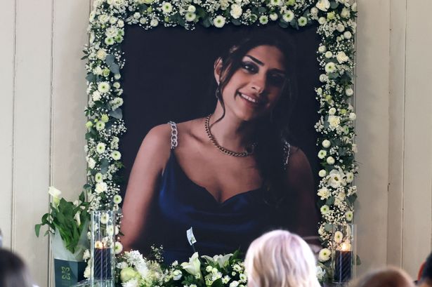 A picture taken from inside the church where mourners paid tribute. It shows a portrait of Paria