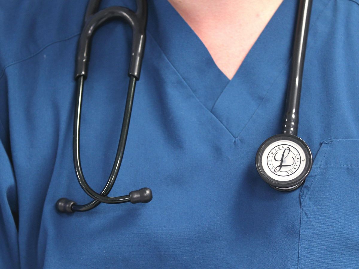 A doctor holding a stethoscope