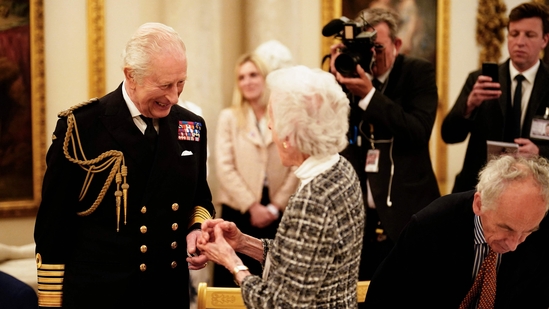 Britain's King Charles III (L) speaks with a Second World War veteran during a tea party at Buckingham Palace on May 5, 2025.(AFP)