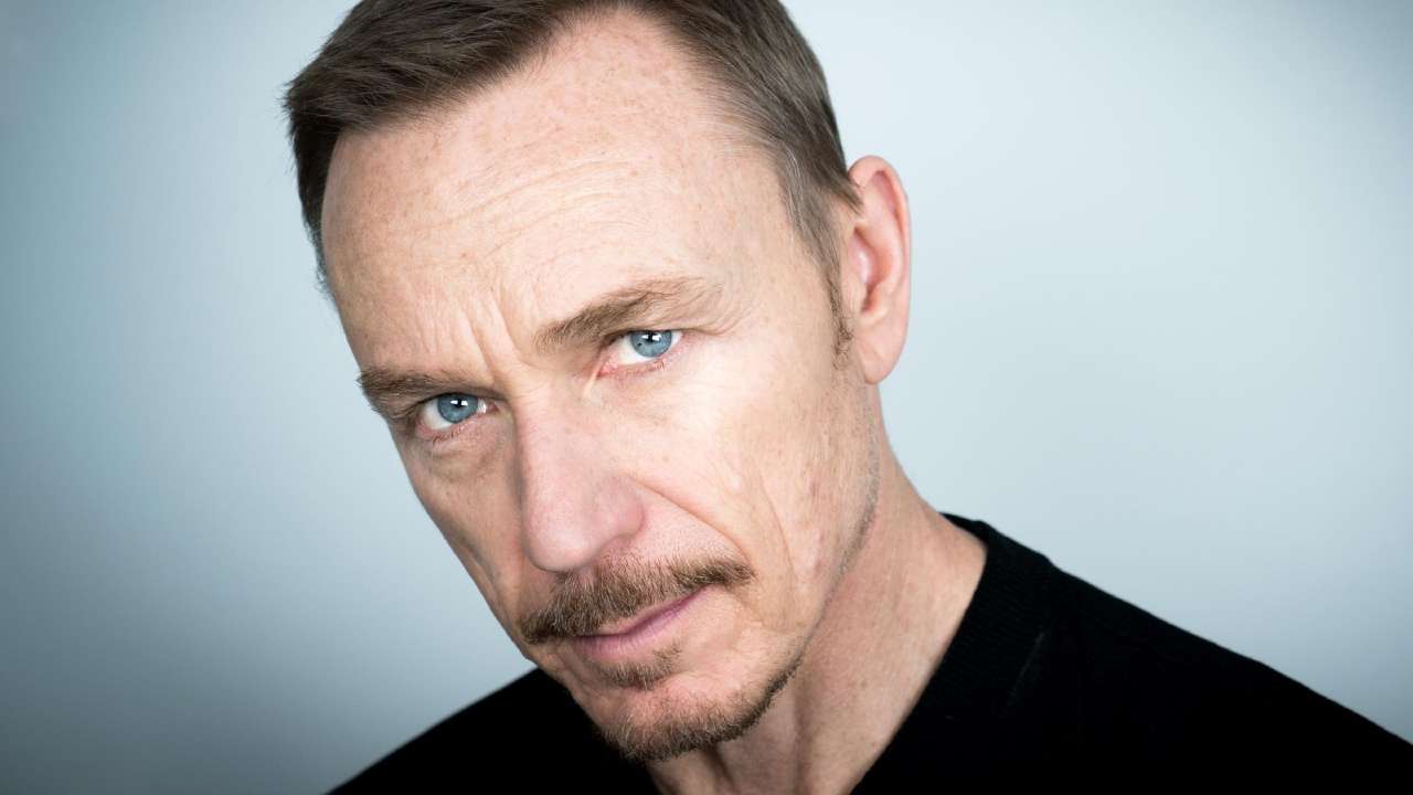 Headshot of actor Ben Daniels