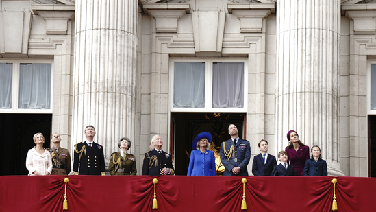 The royal family looks up while the Red Arrows fly past Buckingham Palace.(AP)
