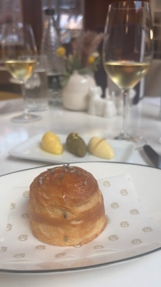 Lavender pastry on a plate with butter pats.