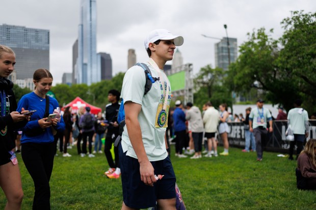 Jared Appel walks through the spring market finish festival after running in the Chicago Spring Half Marathon in Grant Park, May 18, 2025. (Armando L. Sanchez/Chicago Tribune)