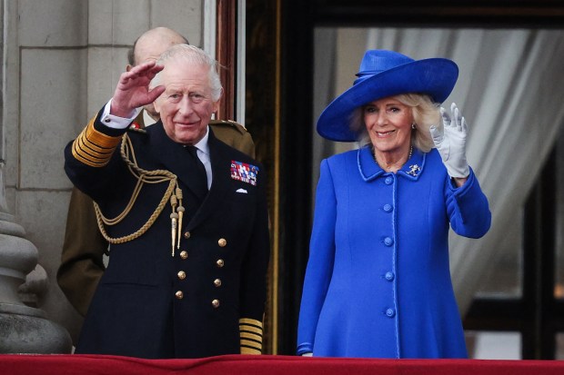 TOPSHOT - Britain's King Charles III and Britain's Queen Camilla wave to crowds, on the balcony of Buckingham Palace after attending the armed forces procession on May 5, 2025 to celebrate the 80th anniversary of VE Day also known as Victory in Europe Day, marking the end of the Second World War in Europe. (Photo by Adrian DENNIS / AFP) (Photo by ADRIAN DENNIS/AFP via Getty Images)