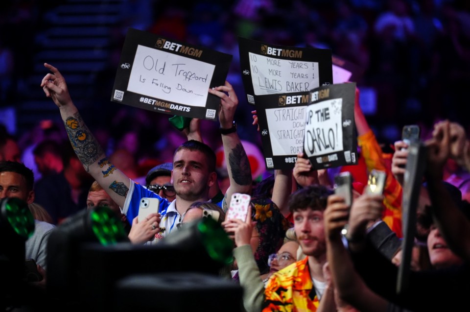Leeds United fans in the crowd taunt Luke Littler before the semi-final match against Gerwyn Price on night fourteen of the BetMGM Premier League at First Direct Arena, Leeds. Picture date: Thursday May 8, 2025. PA Photo. See PA story DARTS Leeds. Photo credit should read: Mike Egerton/PA Wire. RESTRICTIONS: Use subject to restrictions. Editorial use only, no commercial use without prior consent from rights holder.