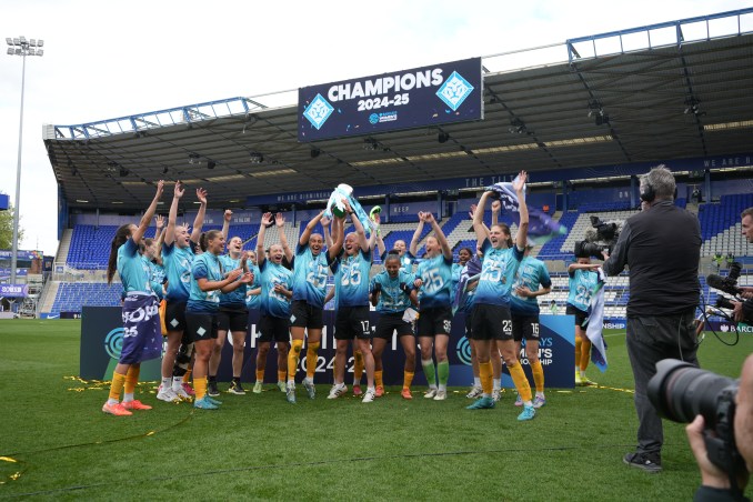 London City Lionesses players celebrate as they lift the Championship trophy.