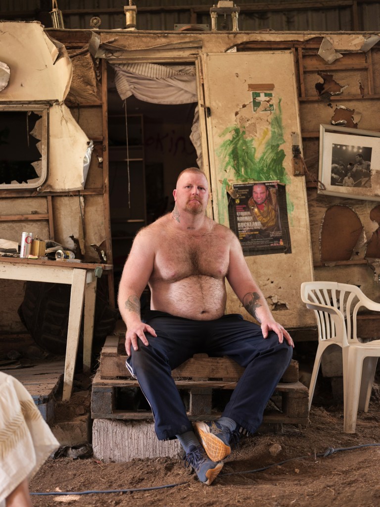 A fighter poses topless at home