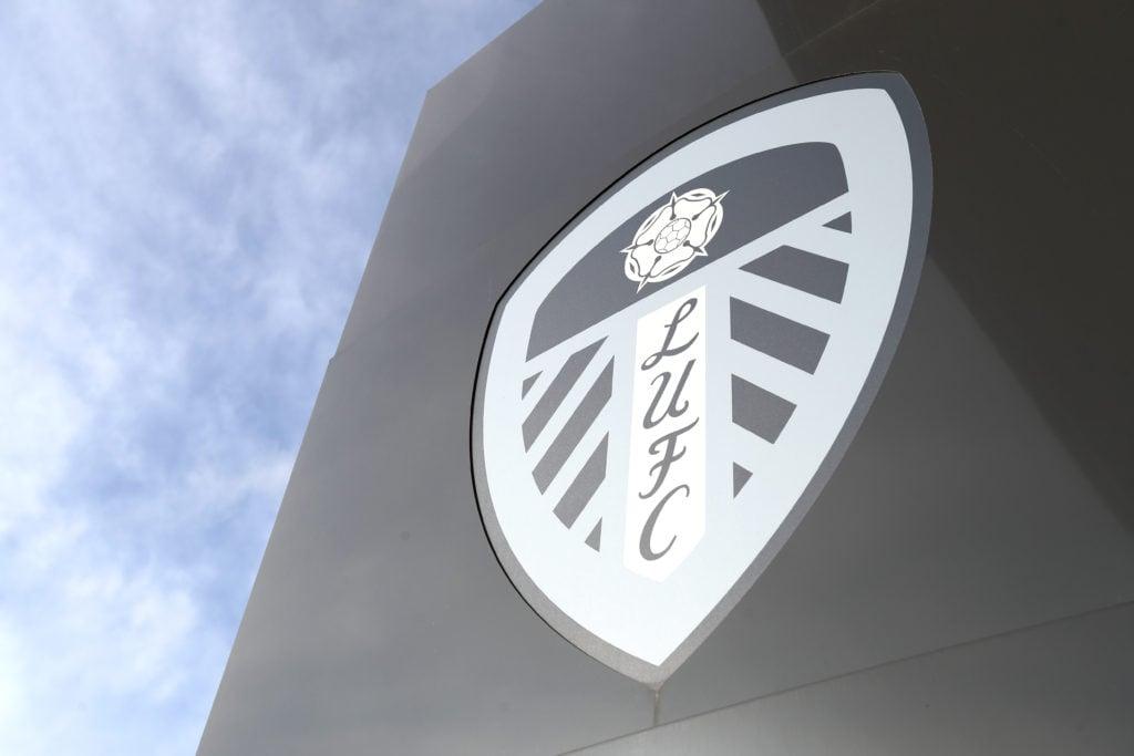 An exterior view of Elland Road showing the Leeds United crest against the backdrop of the sky