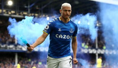 Richarlison of Everton celebrates with a flare after scoring their team's first goal during the Premier League match between Everton and Chelsea at...