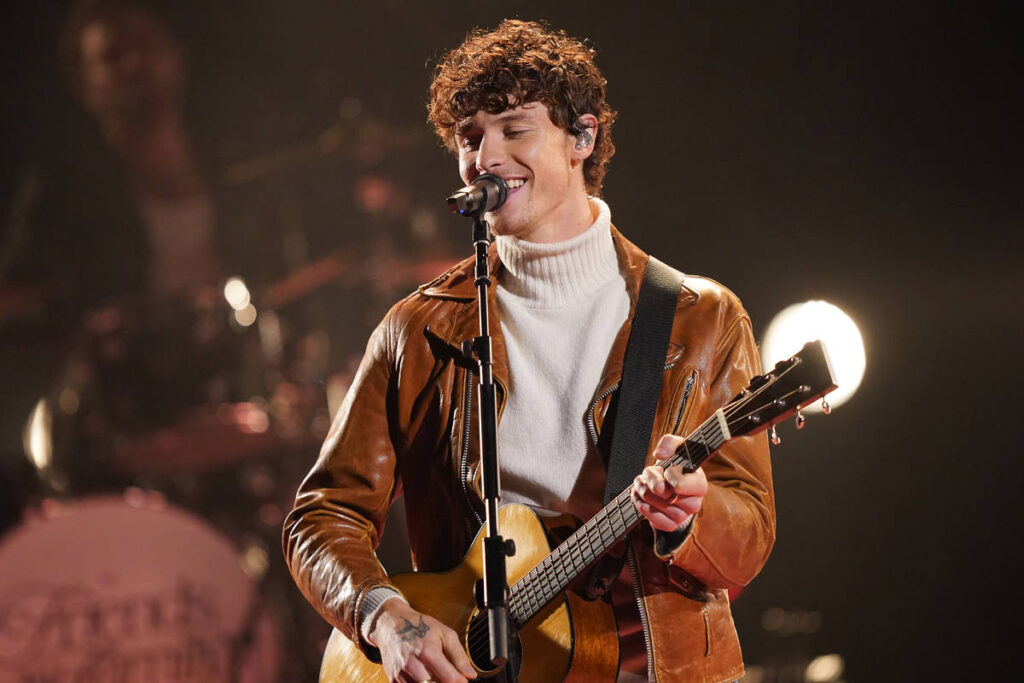 Shawn Mendes singing onstage in Manchester