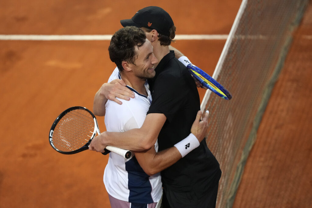Casper Ruud of Norway and Jannik Sinner of Italy hug each other at the net after their Italian Open quarterfinal match