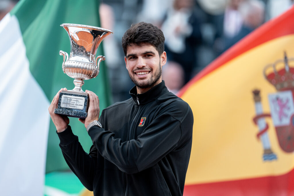 Carlos Alcaraz poses with the Italian Open title after beating Jannik Sinner in the 2025 final