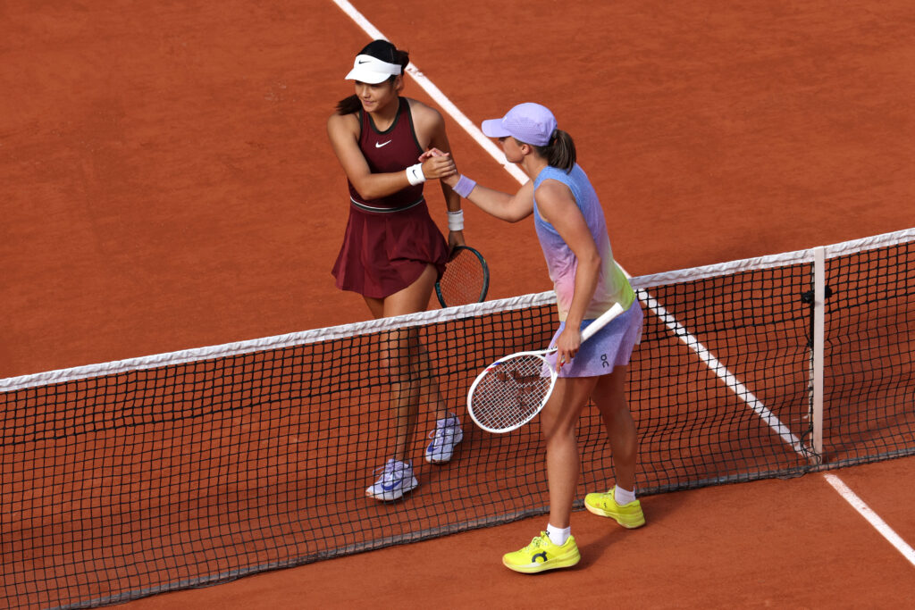Emma Raducanu and Iga Swiatek embrace at the net after their 2025 French Open match