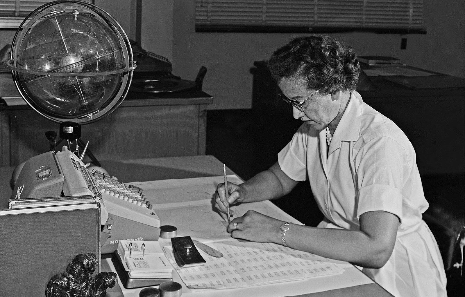 Katherine Johnson performing calculations at her desk at Langley Research Center at NASA