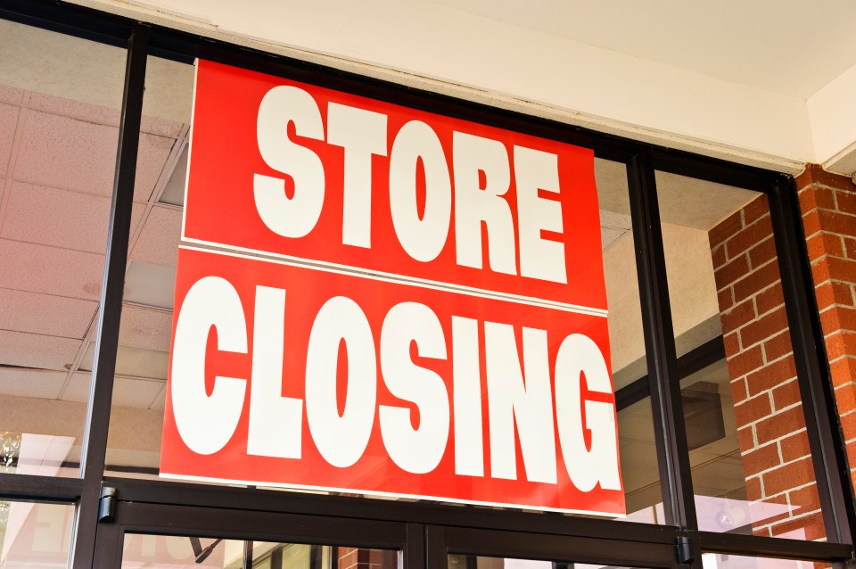 Store closing sign in a storefront window.