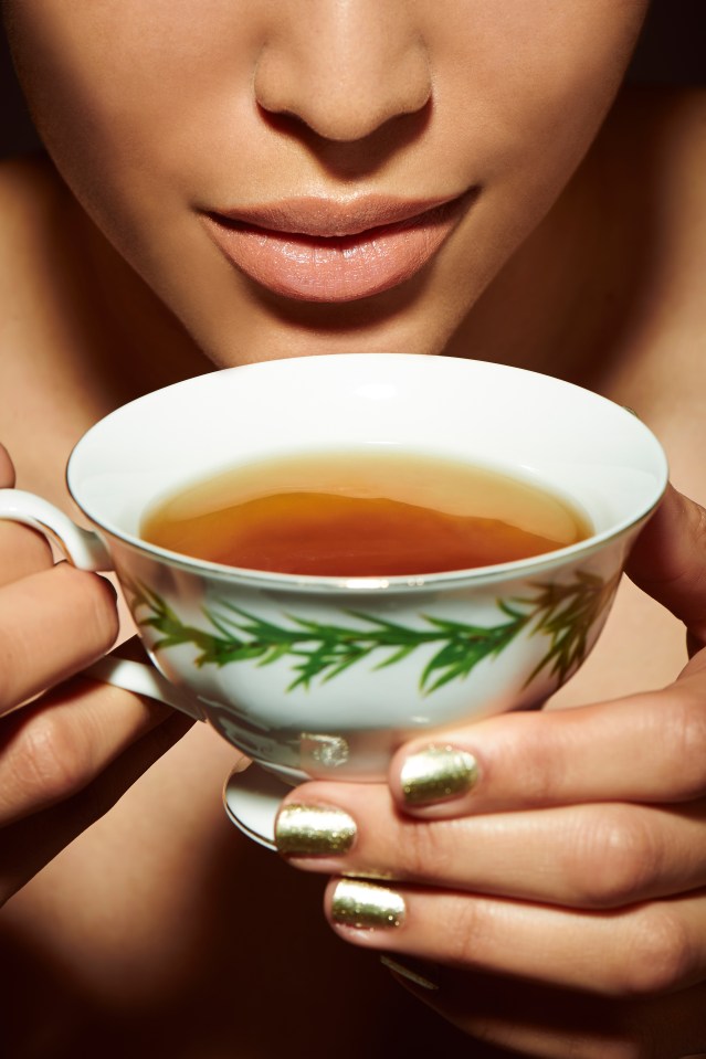 Close-up of a person holding a teacup.