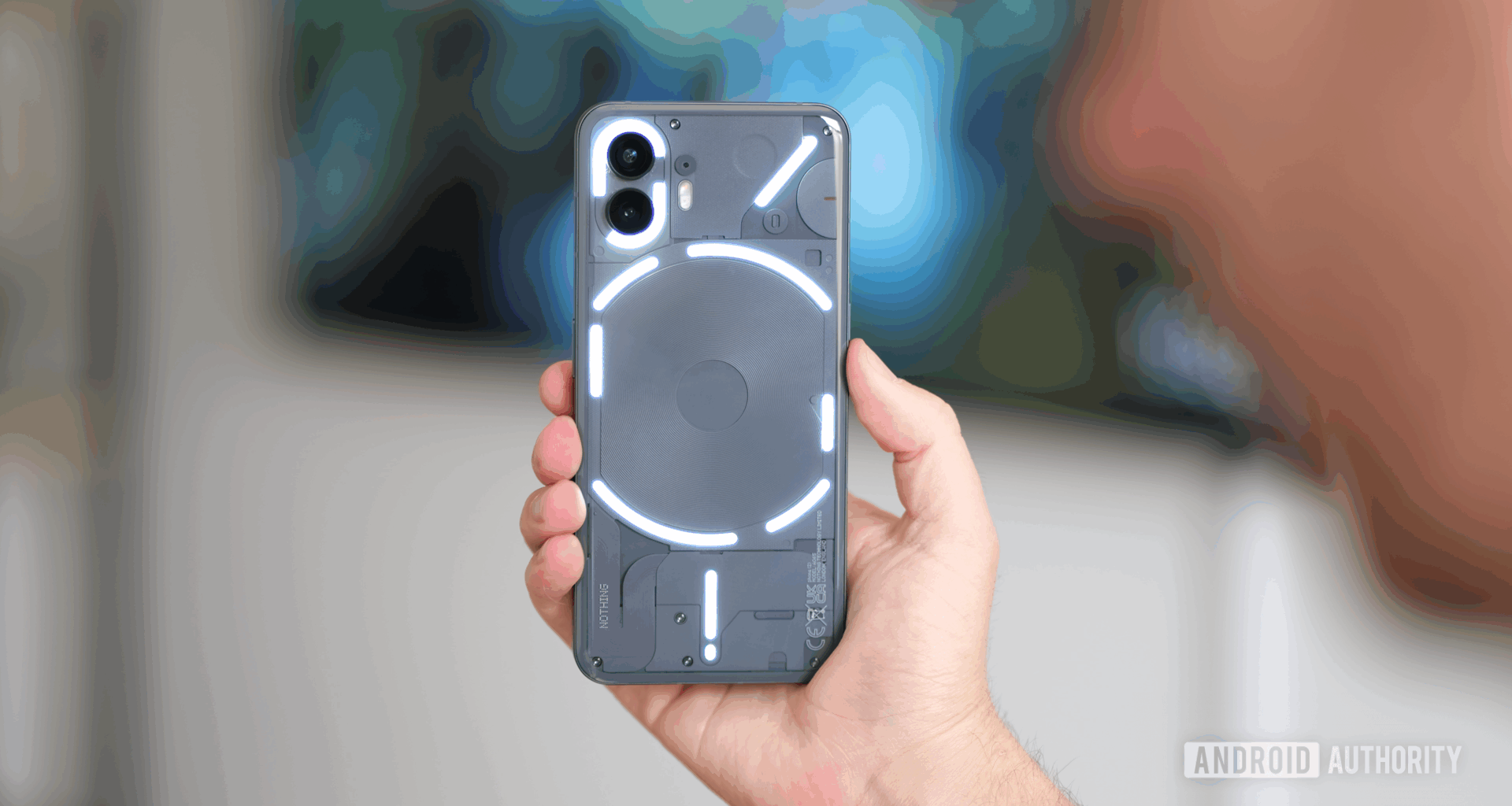 Nothing Phone 2 in gray with glyph lighting enabled