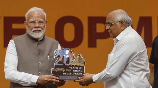 Gandhinagar: Prime Minister Narendra Modi being presented a memento by Gujarat chief minister Bhupendra Patel during an event.(PTI)