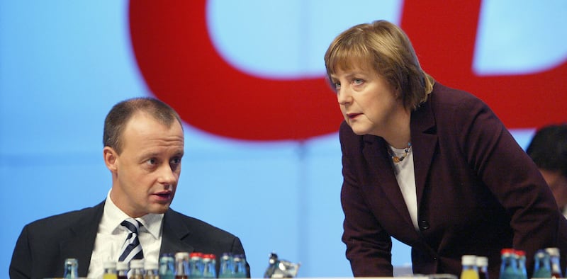 Friedrich Merz and Angela Merkel speak prior to Merz's speech on tax reform at the CDU party congress in 2003. Photograph: Sean Gallup/Getty
