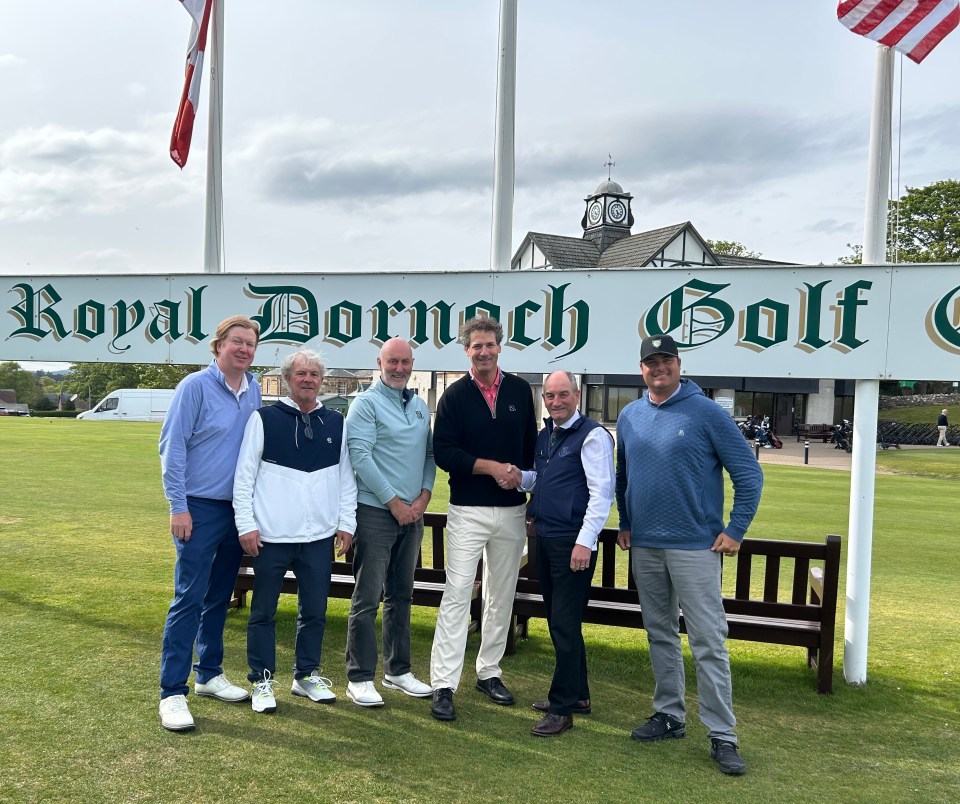 Group of men standing in front of Royal Dornoch Golf Club sign.