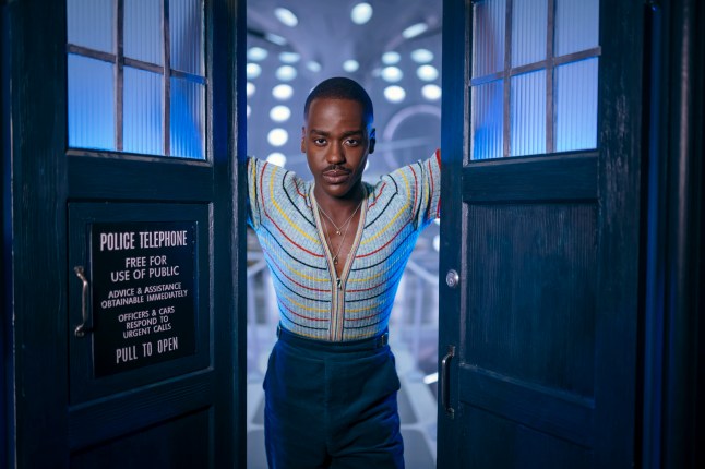 The Doctor looks through the TARDIS doors