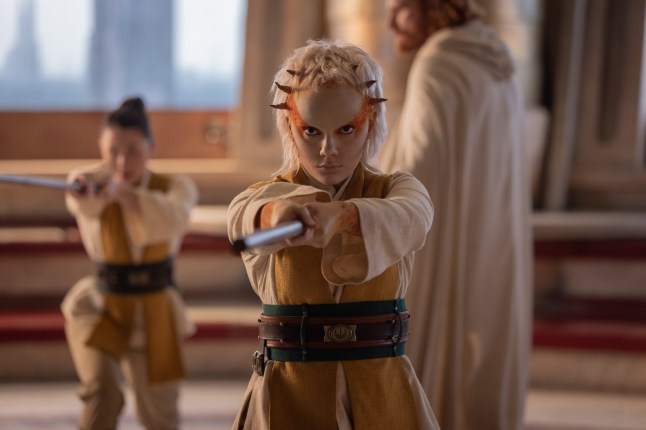 (Center to right): Jedi Padawan Jecki Lon??(Dafne Keen) and Master Lakshay (Paul Bullion) in Lucasfilm's THE ACOLYTE, exclusively on Disney+. ??2024 Lucasfilm Ltd. & TM. All Rights Reserved.