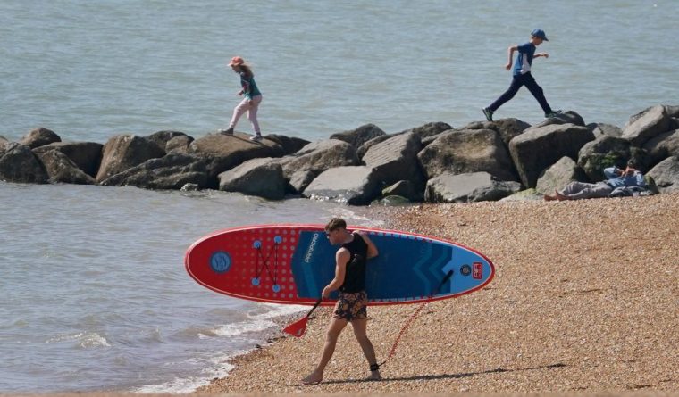 A paddleboarder heads for the sea during the morning sunshine in Dover, Kent, as the warm weather continues across the country with highs of 25C forecast. Picture date: Tuesday April 29, 2025. PA Photo. See PA story WEATHER Warm. Photo credit should read: xxxxx/PA Wire