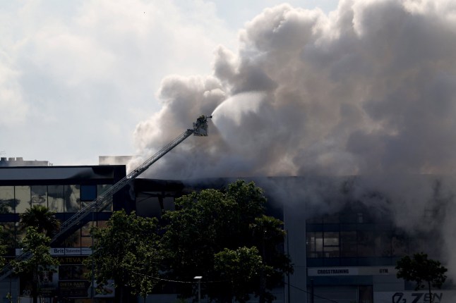 A picture taken on May 10, 2025 shows smoke billowing from a building storing pool cleaning products, in the coastal city of Vilanova i la Geltru, south of Barcelona. Spanish authorities told more than 160,000 people near Barcelona to stay indoors on Saturday after a fire at an industrial property released a toxic cloud of chlorine over a wide area. (Photo by LLUIS GENE / AFP) (Photo by LLUIS GENE/AFP via Getty Images)