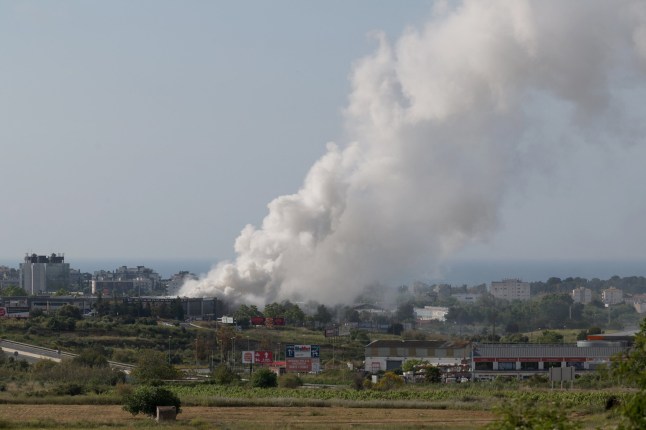 A picture taken on May 10, 2025 shows smoke billowing from a building storing pool cleaning products, in the coastal city of Vilanova i la Geltru, south of Barcelona. Spanish authorities told more than 160,000 people near Barcelona to stay indoors on May 10 after a fire at an industrial property released a toxic cloud of chlorine over a wide area. (Photo by LLUIS GENE / AFP) (Photo by LLUIS GENE/AFP via Getty Images)