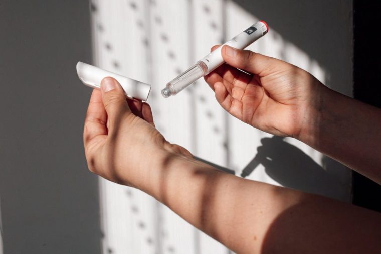 Hands holding a Wegovy injection pen