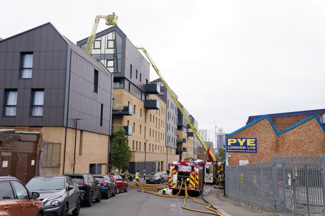Fire fighters use an aerial ladder platform at the scene of a fire.