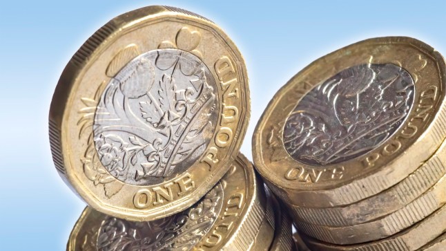 Macro close-up of one pound coins on a white background.