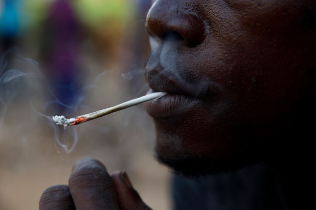 FILE - A young man smokes Kush, a derivative of cannabis mixed with synthetic drugs like fentanyl and tramadol and chemicals like formaldehyde, at a hideout in Freetown, Sierra Leone, April 29, 2024. Traces of highly potent opioids known as nitazenes have for the first time been found to be consumed by people who use drugs in Africa, according to a report released Wednesday, June 12, 2024, by the Global Initiative Against Transnational Organized Crime nonprofit. (AP Photo/ Misper Apawu, File)
