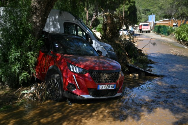 This photograph shows a damaged car on a mud-covered street following a flood caused by heavy rain in Cavaliere village of Le Lavandou commune in the Var department, southeastern France, on May 20, 2025. Intense rainstorms in the southeastern Var department have left at least three people dead, including an octogenarian couple in Le Lavandou, on the coast, authorities reported. (Photo by Christophe Simon / AFP) (Photo by CHRISTOPHE SIMON/AFP via Getty Images)