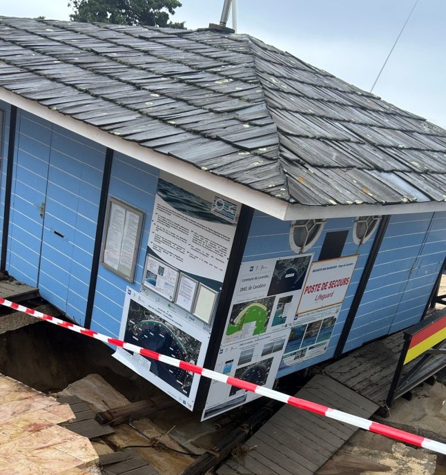 A building partially collapsed from flooding.