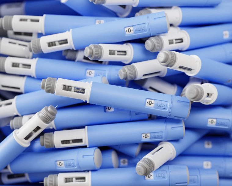 A large group of semaglutide injection pens in a heap