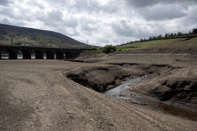 The bed of Woodhead Reservoir is revealed by a falling water level, near Glossop, northern England on May 22, 2025. Data from United Utilities, the United Kingdom's largest listed water company, shows that reservoir levels for the north west of England stands at 61.9% of capacity, down from 88.8% at the same period in 2024. (Photo by Oli SCARFF / AFP) (Photo by OLI SCARFF/AFP via Getty Images)