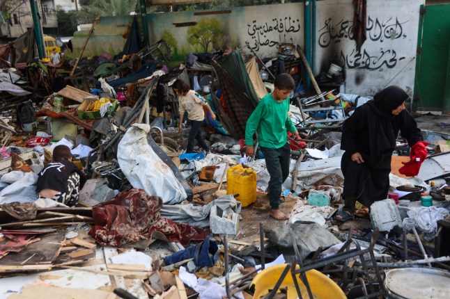 People inspect the damage at the Fahmi Al-Jarjawi School in Gaza City on May 26, 2025, following an Israeli strike. Gaza's civil defence agency said the death toll from an Israeli strike on May 25 on the school turned shelter for displaced people had risen to 33. (Photo by Omar AL-QATTAA / AFP) (Photo by OMAR AL-QATTAA/AFP via Getty Images)