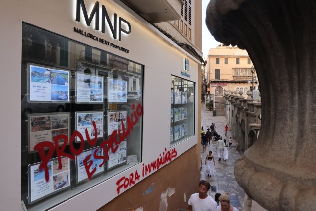 Graffiti protesting property speculation on the facade of a Mallorca Next Properties real estate agent in Palma de Mallorca, Spain, on Saturday, July 20, 2024. In the Spanish destinations of??Mallorca??and the Canary Islands, locals have been??protesting??to reclaim space from visitors. Photographer: Andrey Rudakov/Bloomberg via Getty Images