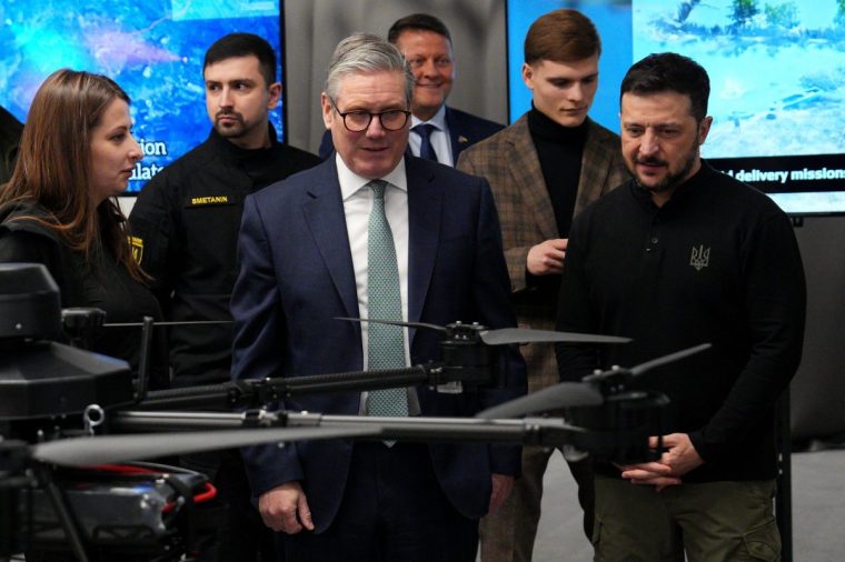 KYIV, UKRAINE - JANUARY 16: British Prime Minister Keir Starmer (C) and Ukrainian President Volodymyr Zelensky (R) attend a presentation of Ukrainian military drones at an undisclosed location on January 16, 2025 in Kyiv, Ukraine. The British Prime Minister is in Ukraine to sign what Downing Street described as a "landmark 100-year partnership" with Ukraine that formalises economic and military support pledged to the country by the UK. It was Starmer's first visit since becoming prime minister. (Photo by Carl Court/Getty Images)