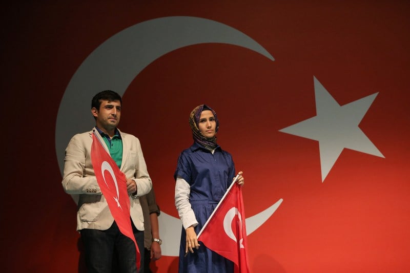 Sumeyye Bayraktar and Selcuk Bayraktar, Turkish President Recep Tayyip Erdogan’s daughter and son-in-law, hold Turkish flags in front of Erdogan’s residence in Kisikli.