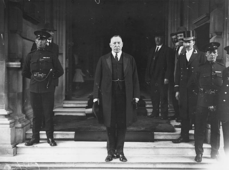 Sir James Craig, the first prime minister of Northern Ireland, standing on steps beside police officers