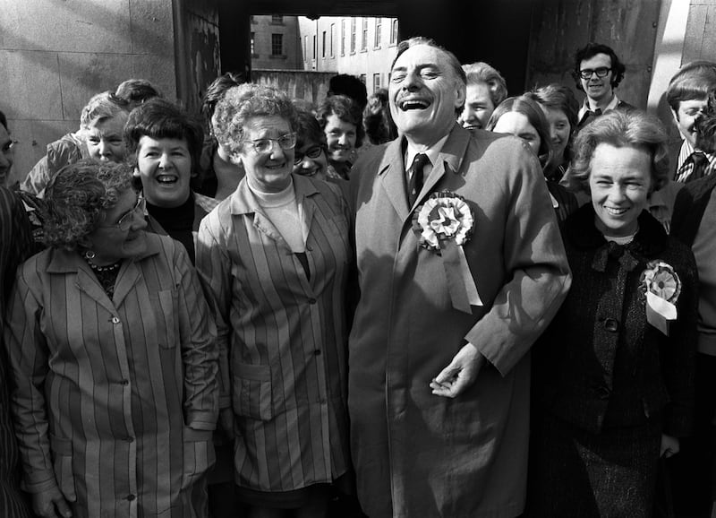 Former Conservative cabinet minister Enoch Powell laughing with his wife Pamela (wearing rosette) and supporters during his election campaign as an United Ulster Unionist candidate for South Down