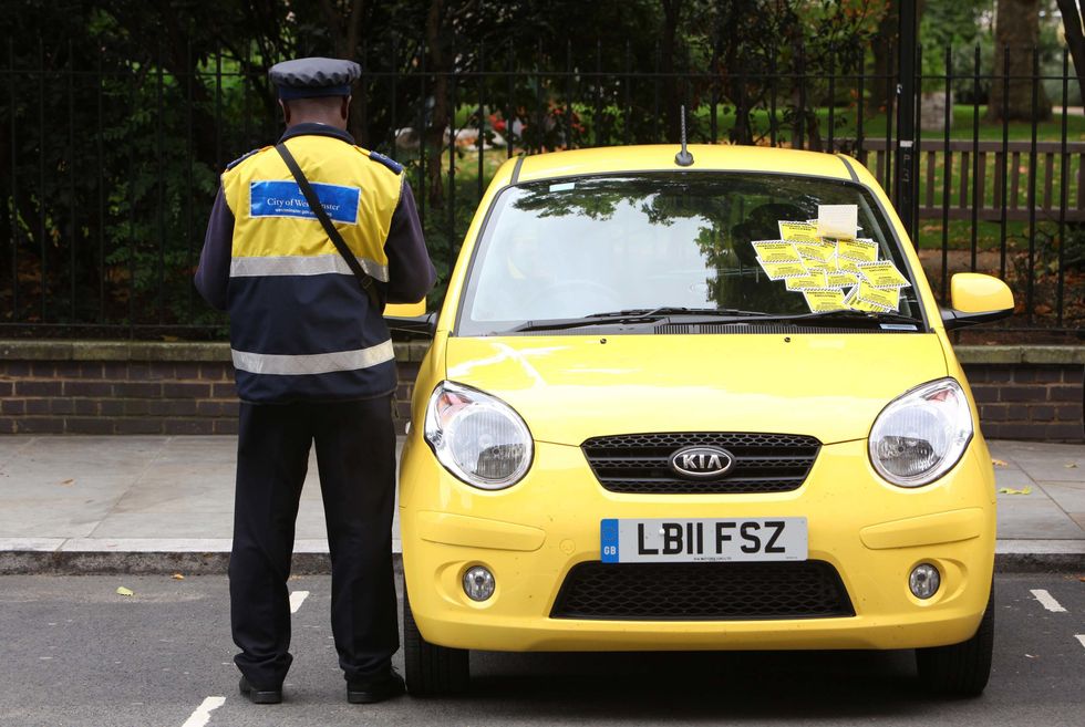 A parking warden issuing fines